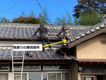 二名の職人が屋根に登り屋根修理の準備をする