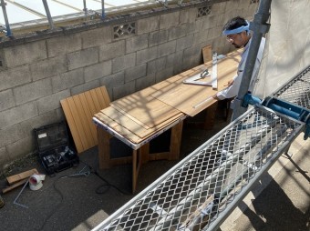 寸法を測り軒天を切り出す職人