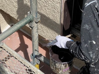 刷毛とローラーを使い分けながら戸袋を塗装する職人