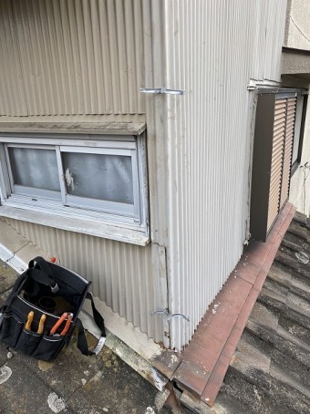 2階のトタン壁に竪樋の支持金具であるデンデンを施工