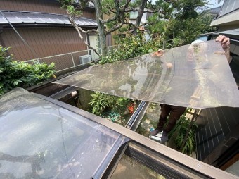 古河市で破損したカーポートパネルを持ち上げる職人