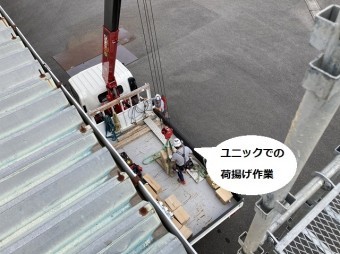 ユニックで荷揚げ作業を行う様子を屋根上から撮影