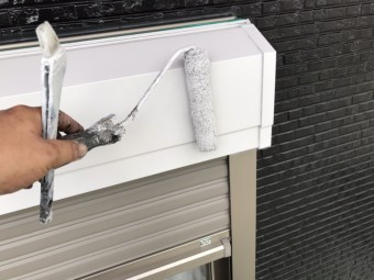 シャッターボックスに白の下塗り材をローラーで塗布