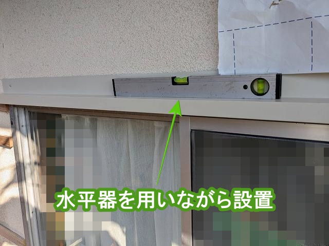 水平器を用いながら窓上水切りを設置