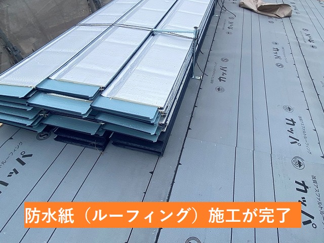 ルーフィングの施工が完了した屋根に屋根材であるSGL鋼板を待機させる